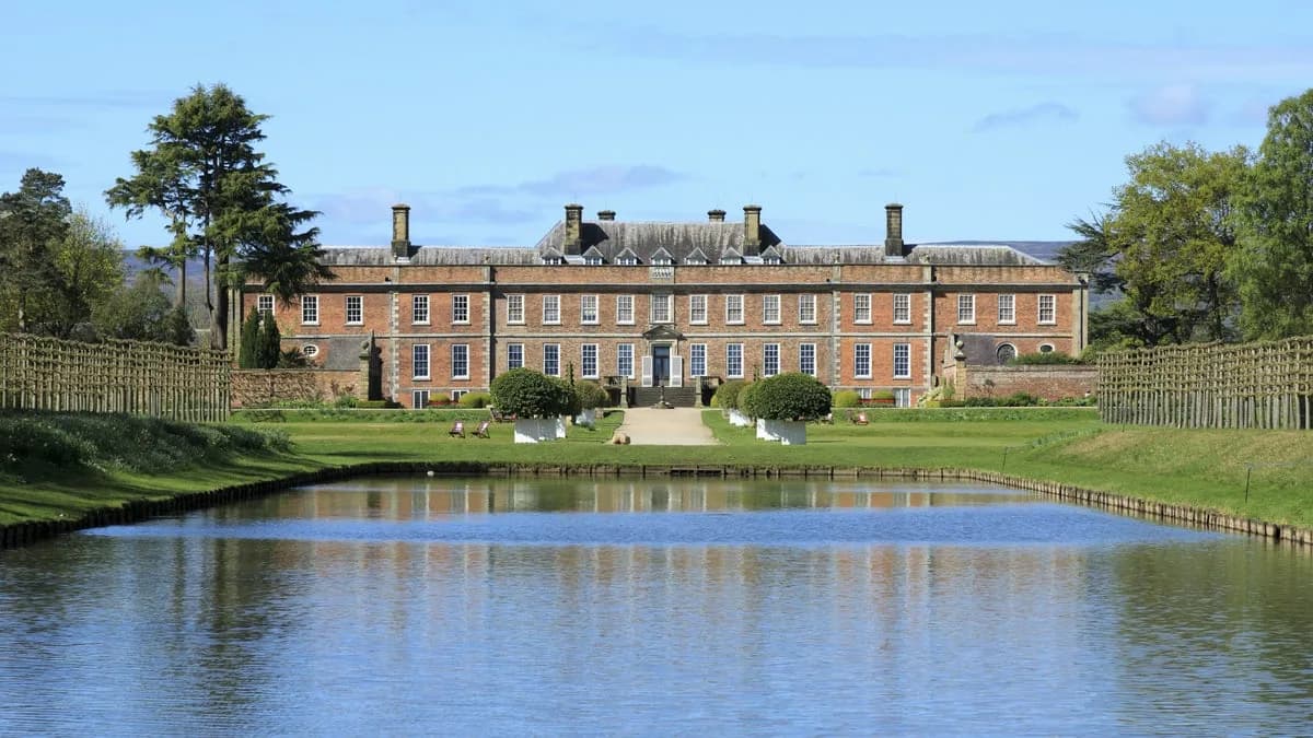Erddig: the 18th-century house seen across the lake in spring