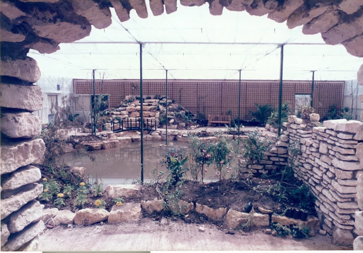 Tropical flight area at Stratford Butterfly Farm with pond and rockery