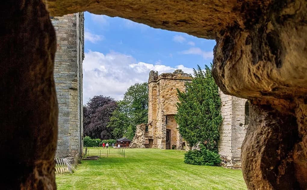 Ashby de la Zouch Castle ruins seen through a stone archway