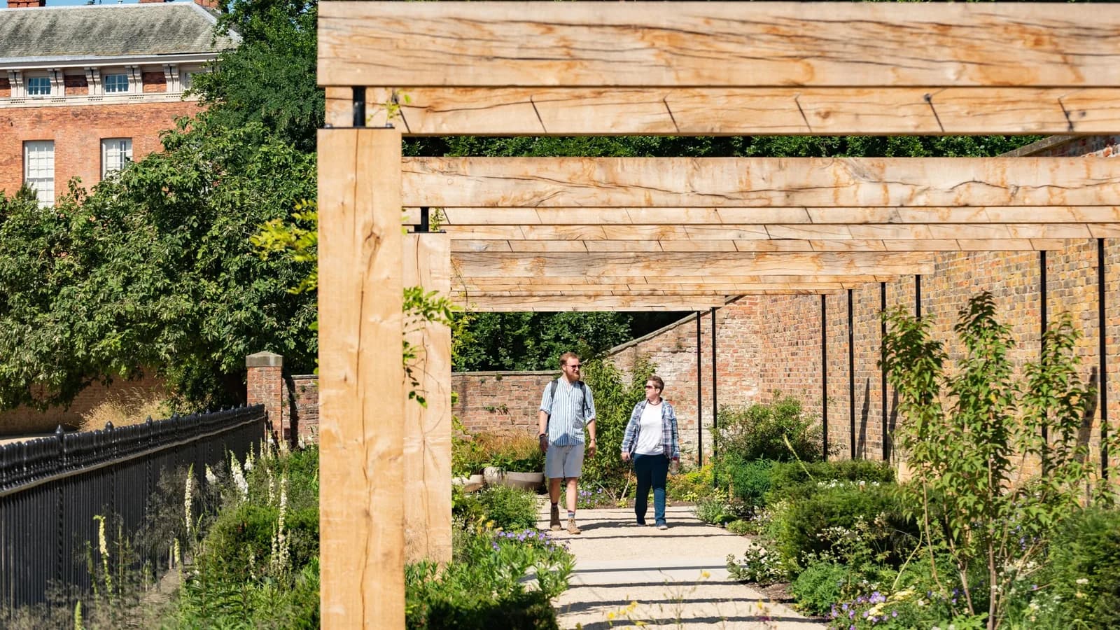 Visitors exploring the Pergola garden at Beningbrough Hall and Gardens, North Yorkshire