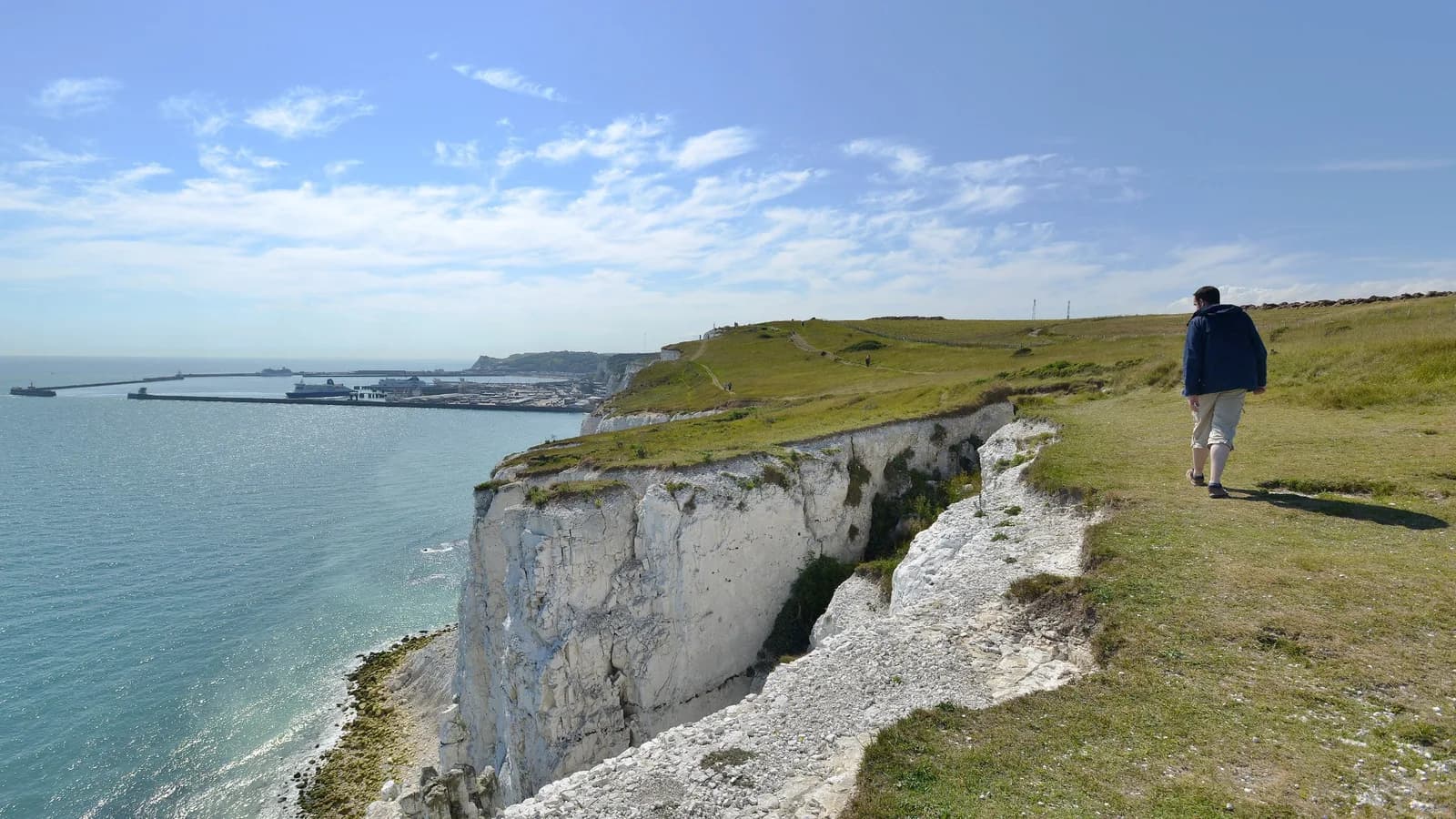 Visitor walking along the clifftop at the White Cliffs of Dover, Kent