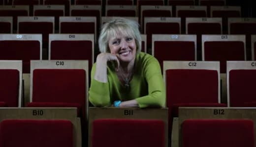 Raked red-velvet seating inside the intimate auditorium of The Bear Pit Theatre, Stratford-upon-Avon