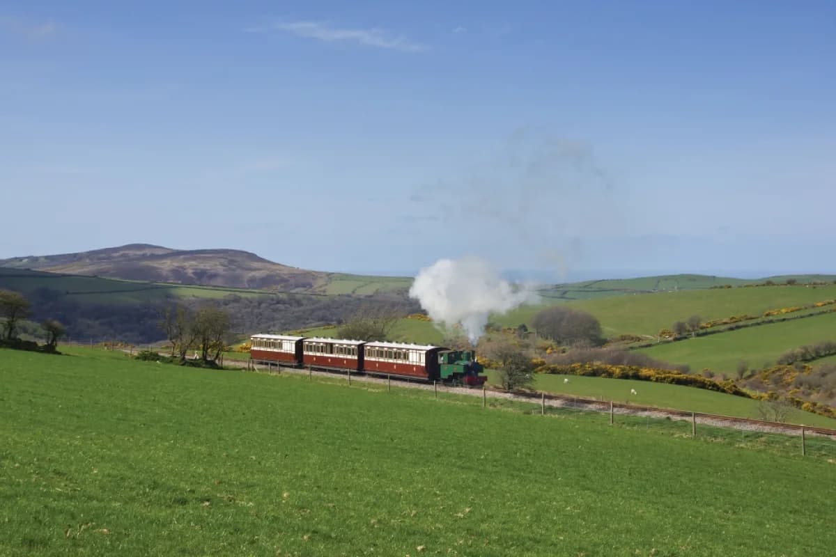Lynton & Barnstaple Railway steam train with Victorian carriages crossing Exmoor