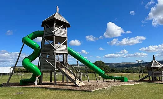 Children playing in the outdoor adventure play area at Hall Hill Farm